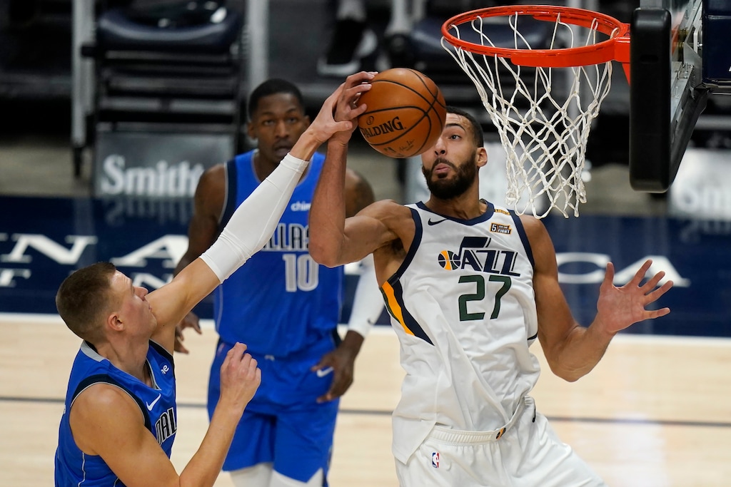 Dallas Mavericks forward Kristaps Porzingis, left, defends against Utah Jazz center Rudy Gobert (27) in the first half during an NBA basketball game Wednesday, Jan. 27, 2021, in Salt Lake City. (AP Photo/Rick Bowmer)