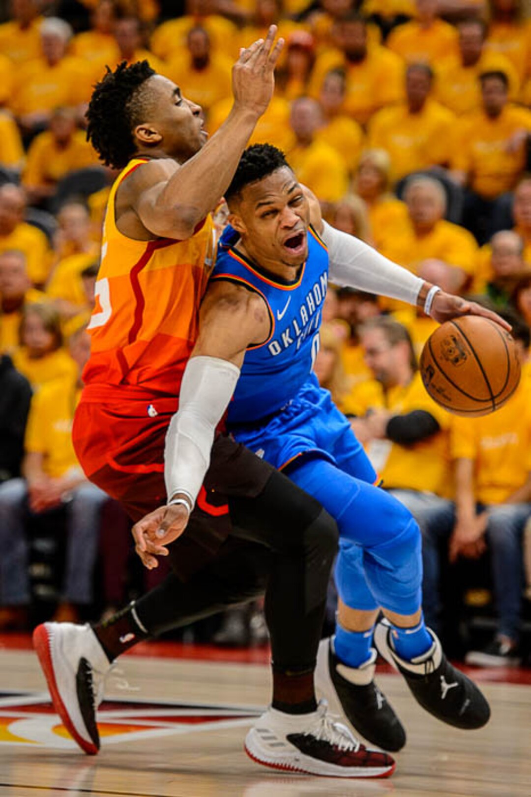 (Trent Nelson | The Salt Lake Tribune)  Utah Jazz host the Oklahoma City Thunder, Game 3, NBA playoff basketball in Salt Lake City, Saturday April 21, 2018. Utah Jazz guard Donovan Mitchell (45) fouls Oklahoma City Thunder guard Russell Westbrook (0).