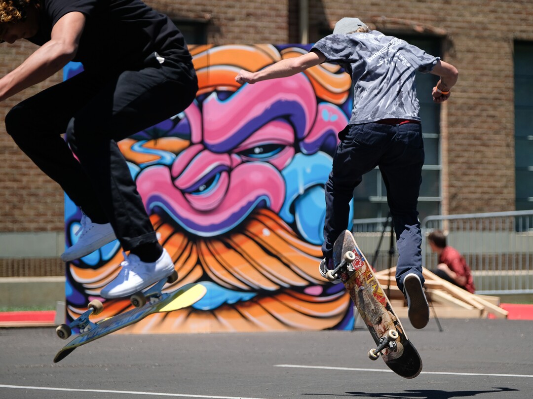 (Francisco Kjolseth  |  The Salt Lake Tribune)  Spray paint art created by local artists acts as a backdrop to a "games of skate" challenge where tricks are tried to be reproduced as the Ogden Arts Festival brings local and regional artists, creatives and entertainers to Ogden, UT on June 8th and 9th. The Ogden Arts Festival returned to the historic Union Station located in the heart of downtown. Managed by Nurture the Creative Mind and held as a fundraiser for the organization, the event was complete with artist booths, music, theater, kidÕs activities, urban arts area, skateboarding games and artisan food vendors.