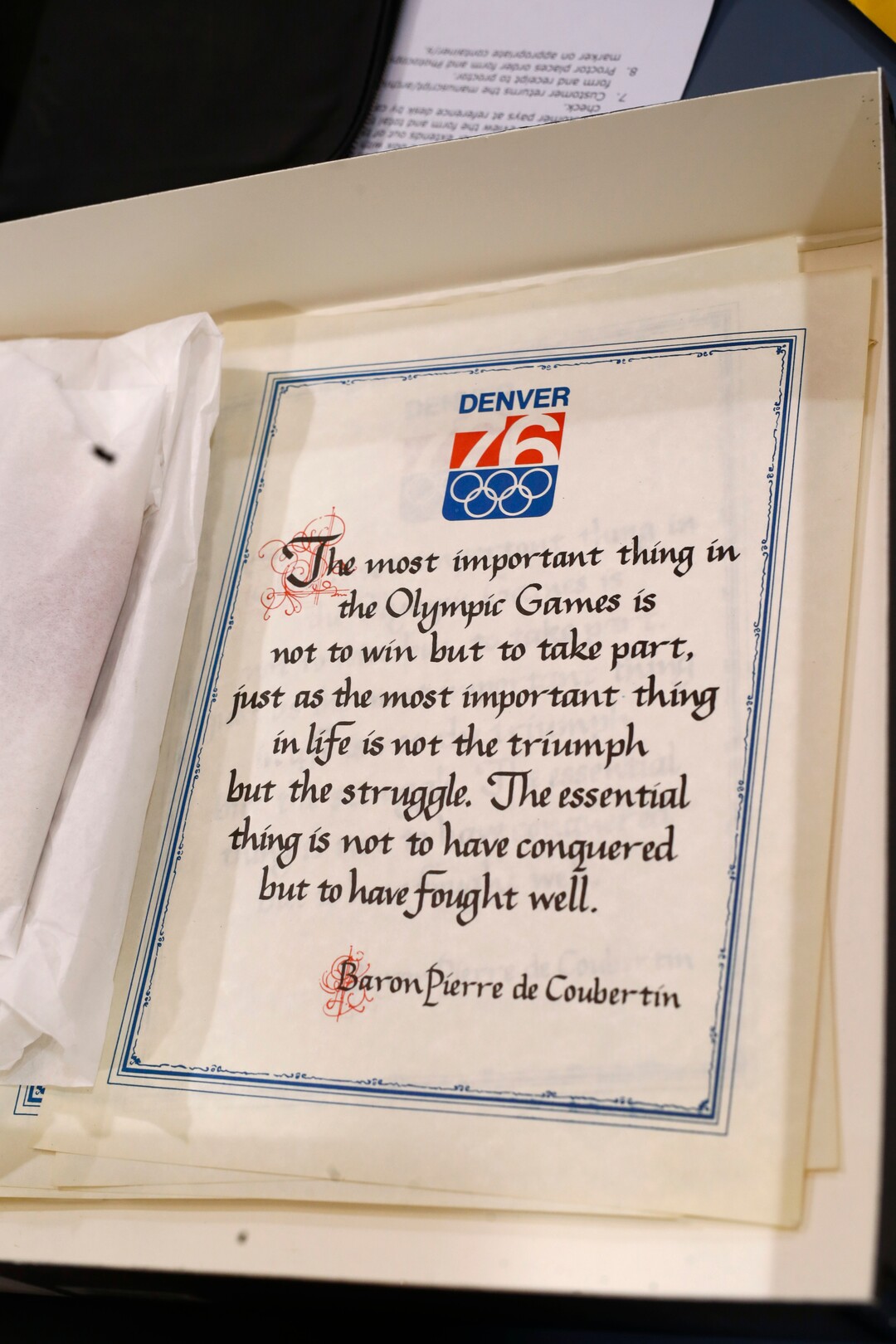 In this Feb. 1, 2018, photo, a proclamation used in Colorado's effort to secure an Olympic bid in 1976 is part of the memorabilia collection of the Denver Public Library in Denver. Over 40 years after becoming the first city to walk away from an Olympic bid, Denver is considering whether to try to again to host the Winter Games. (AP Photo/David Zalubowski)