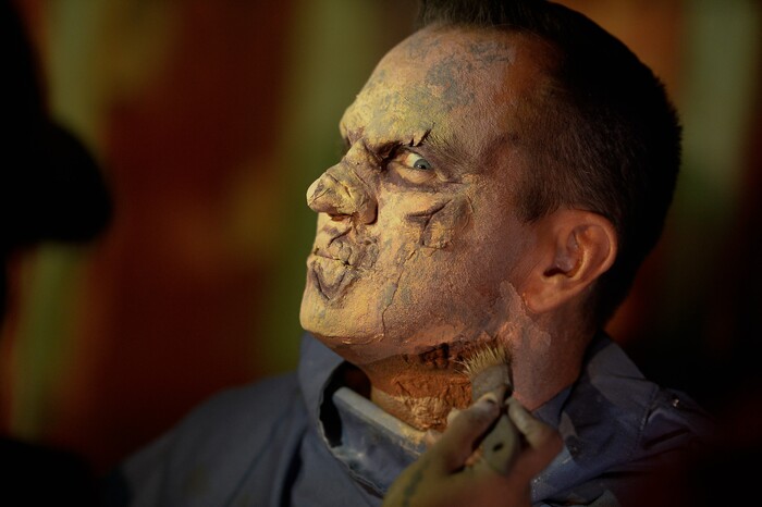 (Francisco Kjolseth  |  The Salt Lake Tribune)  Utah House Speaker Greg Hughes falls prey to the zombie apocalypse with the help of makeup artist Becky Manuel at the Fear Factory on Thursday, Oct. 12, 2017, for a special event to raise awareness of the Utah Food Bank and kick start donations. 