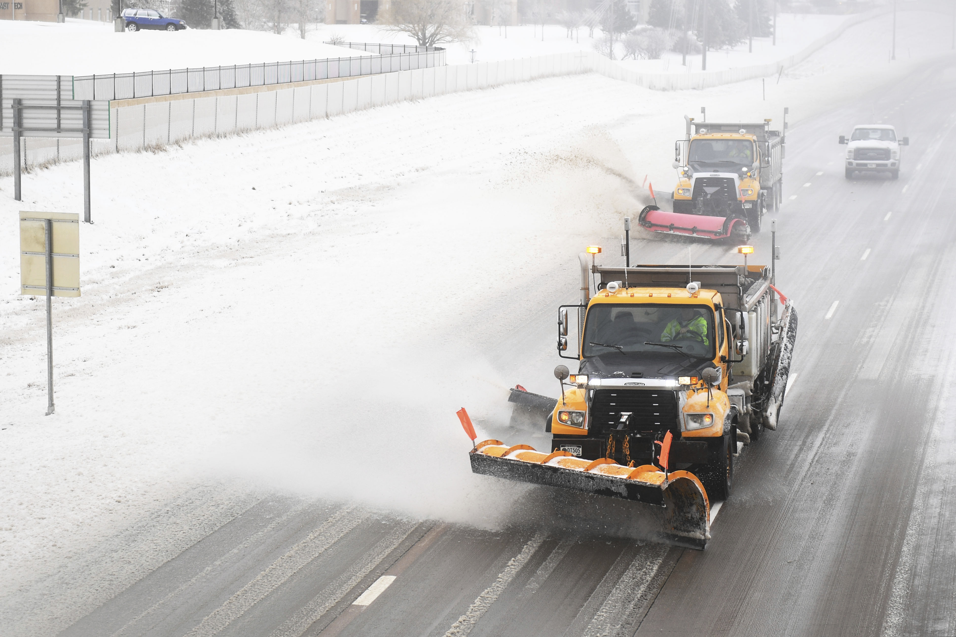 Snow plows clear Interstate 29 on Thursday, April 11, in Sioux Falls, S.D. Heavy snow and strong winds hammered parts of the central U.S. on Thursday, knocking out power to tens of thousands of people and creating hazardous travel conditions a day after pummeling Colorado. (Briana Sanchez/The Argus Leader via AP)