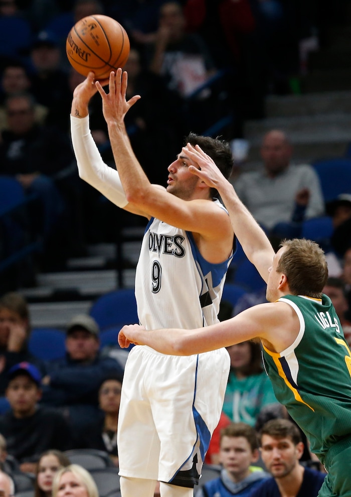 Minnesota Timberwolves' Ricky Rubio, left, of Spain, shoots as Utah Jazz's Joe Ingles, of Australia, defends during the first quarter of an NBA basketball game Saturday, Jan. 7, 2017, in Minneapolis. (AP Photo/Jim Mone)