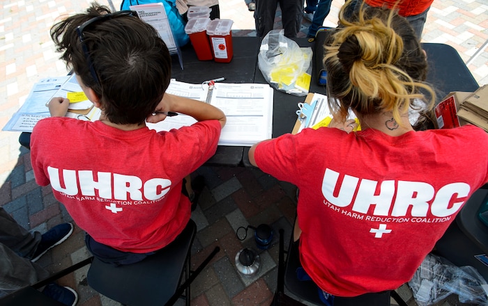 (Steve Griffin  |  The Salt Lake Tribune)  Members from the Utah Harm Reduction Coalition fill out cards for users as they exchange needles on 500 West between 200 South and 300 South in Salt Lake City Thursday,  July 27, 2017. The state's increased attention to the Rio Grande neighborhood comes as Utah's leading needle-exchange provider is under fire for handing out more needles than it collects. Mindy Vincent, founder of the coalition, says the goal was never to break even, and that optics aside, needle exchange is proven to reduce the spread of disease among IV drug users.