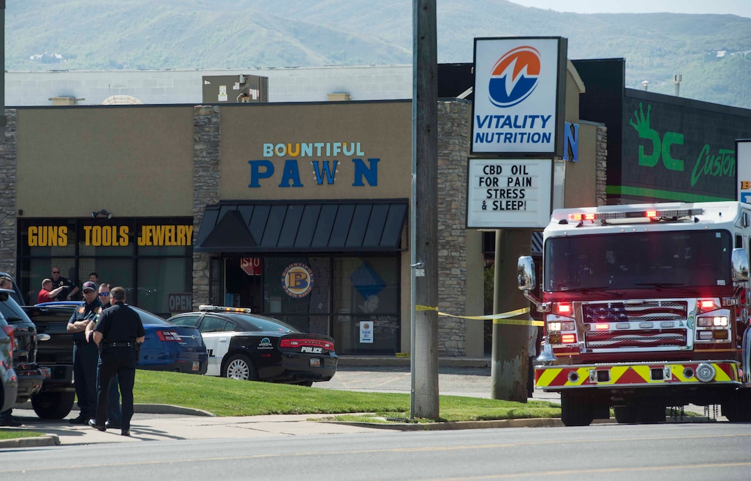 (Rick Egan | The Salt Lake Tribune) Bountiful police investigate after they say a store clerk shot an armed robbery suspect at Bountiful Pawn and Sales on Thursday, May 3, 2018. Police are looking for a second suspect in the attempted armed robbery.