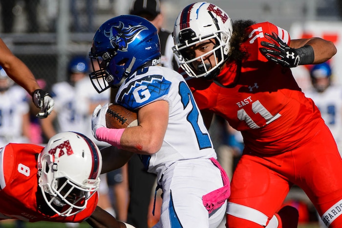 (Trent Nelson | The Salt Lake Tribune)
Pleasant Grove's Dayne Christiansen (20) runs the ball as East hosts Pleasant Grove in the first round of the 6A high school football playoffs, Friday Oct. 26, 2018.