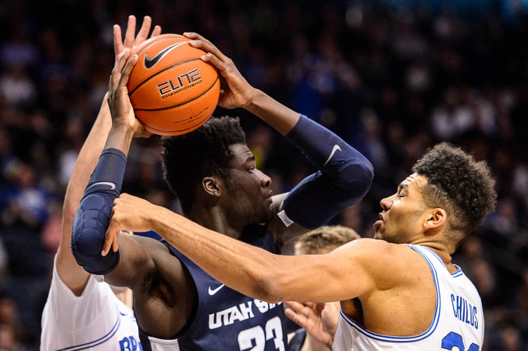 (Trent Nelson | The Salt Lake Tribune)  Utah State Aggies center Neemias Queta (23) defended by Brigham Young Cougars forward Yoeli Childs (23) as BYU hosts Utah State, NCAA basketball in Provo on Wednesday Dec. 5, 2018.
