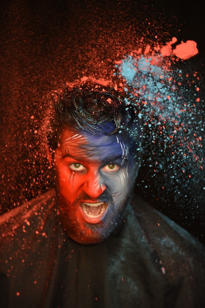 (Francisco Kjolseth | The Salt Lake Tribune) BYU and Utah fan alike Brad Klekas of South Jordan shows his mutual admiration by stepping into the Tribune studio to get both colors in anticipation of the upcoming match up between the two rival teams on Saturday.