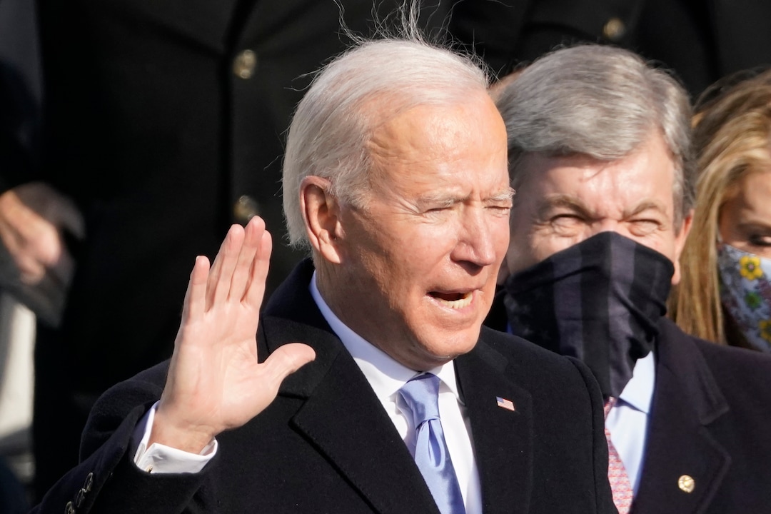 Joe Biden is sworn in as the 46th president of the United States by Chief Justice John Roberts as Jill Biden holds the Bible during the 59th Presidential Inauguration at the U.S. Capitol in Washington, Wednesday, Jan. 20, 2021. (AP Photo/Andrew Harnik)