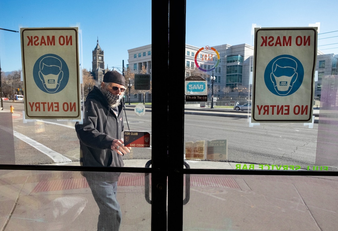 (Francisco Kjolseth  | The Salt Lake Tribune) A customers enters the Green Pig Pub in Salt Lake City on Thursday, Dec. 3, 2020, during the lunch hour. The owners of 25 different Utah bars — including the Green Pig Pub —  have sent a letter to Gov. Gary Herbert protesting the state health order that requires alcohol service to stop at 10 p.m They say the restriction is devastating the bar industry in Utah and has caused hundreds of thousands of dollars in lost  revenue, hurt employees, and could force many to close.