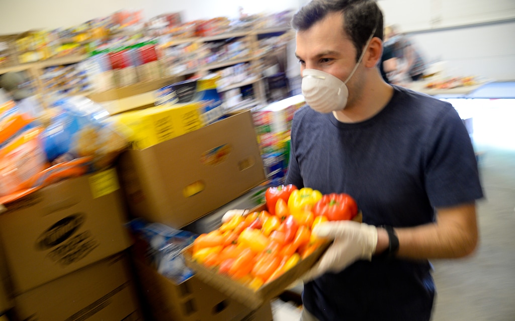(Francisco Kjolseth | The Salt Lake Tribune) Andrew Marx takes peppers to the pick up window after sorting through any spoiled items as he joins other volunteers sorting through donated food at the Taylorsville Food Pantry on Saturday, May 30, 2020. Census reports a third of Utahns say they are not getting enough to eat during coronavirus pandemic