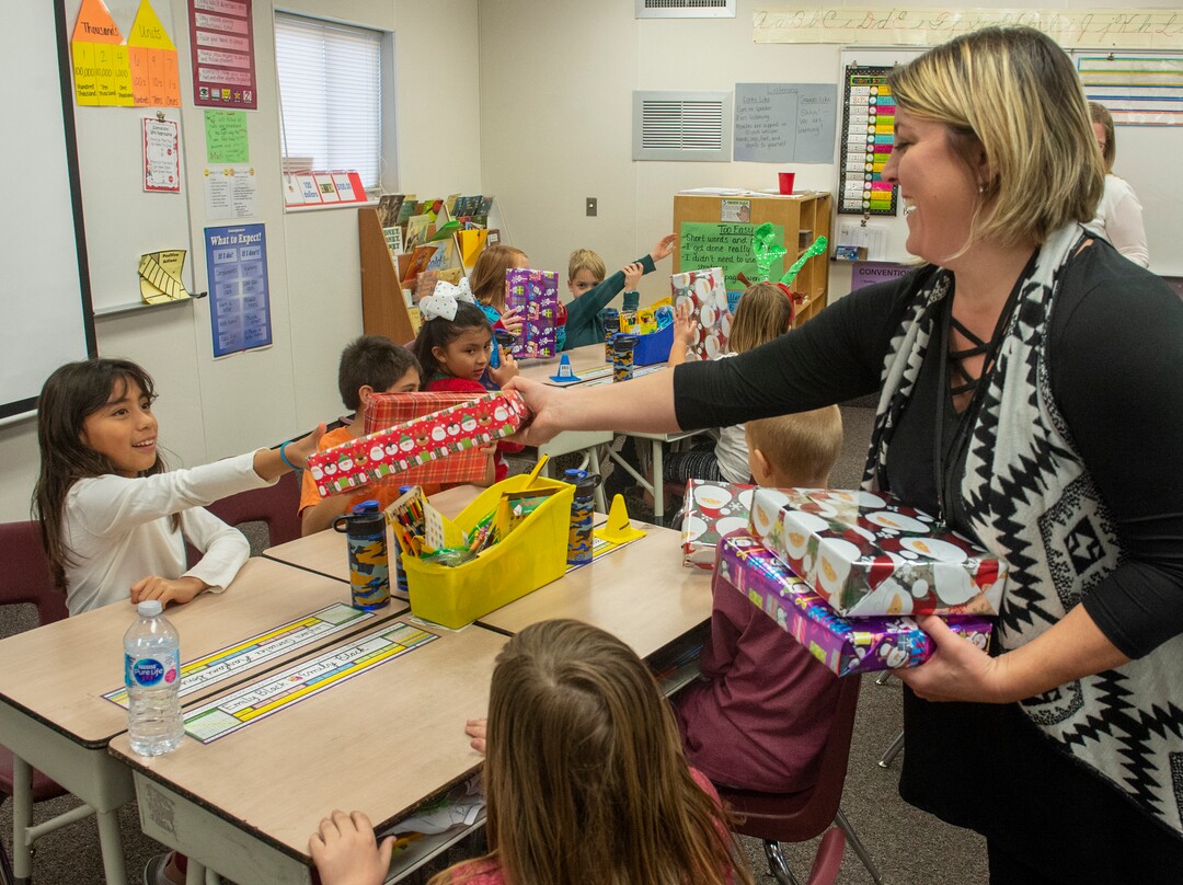 (Rick Egan  |  The Salt Lake Tribune)  Brooke Payton, thrived grade teacher, passes out boxes of cereadsl to her class. Ms. Worthington the principal of Oquirrh Elementary hands out cereal to a third grade class. She surprised all 650 students at her school with the gift-wrapped boxes of cereal, West Jordan, Thursday, Dec. 20, 2018.