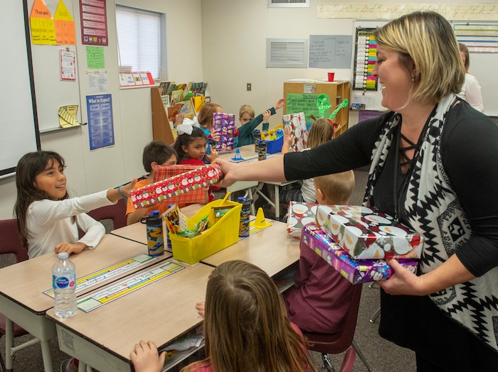 (Rick Egan  |  The Salt Lake Tribune)  Brooke Payton, thrived grade teacher, passes out boxes of cereadsl to her class. Ms. Worthington the principal of Oquirrh Elementary hands out cereal to a third grade class. She surprised all 650 students at her school with the gift-wrapped boxes of cereal, West Jordan, Thursday, Dec. 20, 2018.


