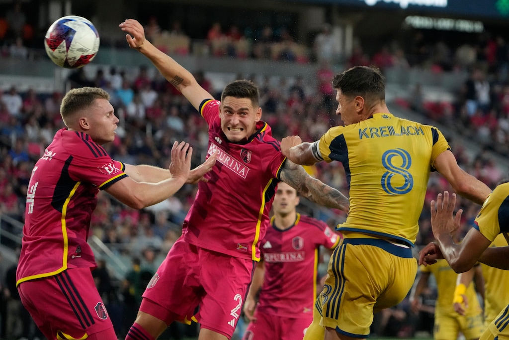 (Jeff Roberson | AP) Real Salt Lake's Damir Kreilach (8) heads the ball past St. Louis City's Jake Nerwinski (2) and John Nelson (14) during the first half of an MLS soccer match Wednesday, June 21, 2023, in St. Louis.
