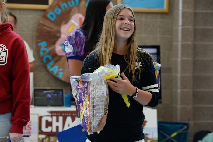 (Francisco Kjolseth | The Salt Lake Tribune) Sam Gordon, 14, works her fellow students at Herriman High School in an effort to sign up girls to play football during a recent clubs sign up day. Brent Gordon and his daughter, Sam, are part of a group suing multiple school districts to try to force the creation of sanctioned girls high school football that would play in the Spring.