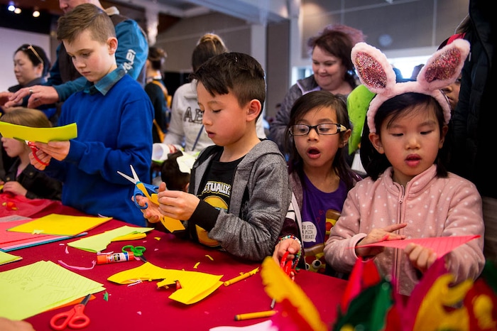 (Trent Nelson | The Salt Lake Tribune)  Children work on origami at the Chinese New Year Celebration at the County Library's Viridian Event Center in West Jordan, Saturday Feb. 17, 2018.