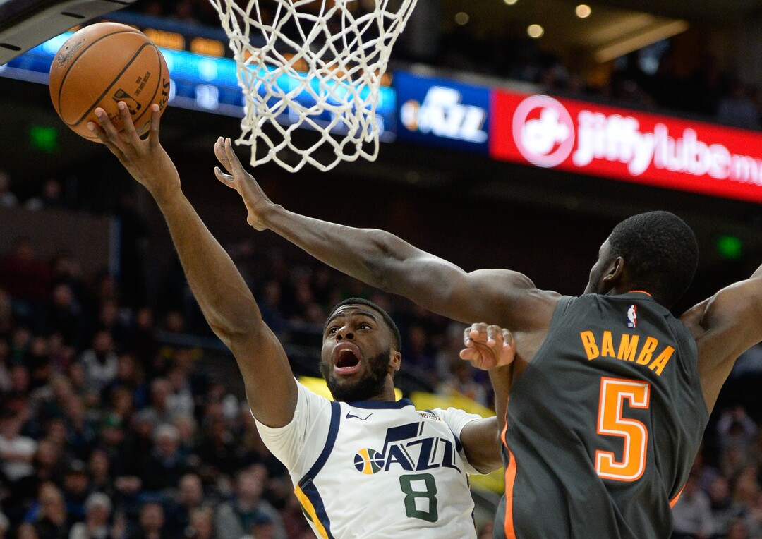 (Francisco Kjolseth  |  The Salt Lake Tribune) Utah Jazz guard Emmanuel Mudiay (8) reaches past Orlando Magic center Mo Bamba (5) as the Utah Jazz host the Orlando Magic in their NBA basketball game at Vivint Smart Home Arena in Salt Lake City on Tuesday. Dec. 17, 2019.