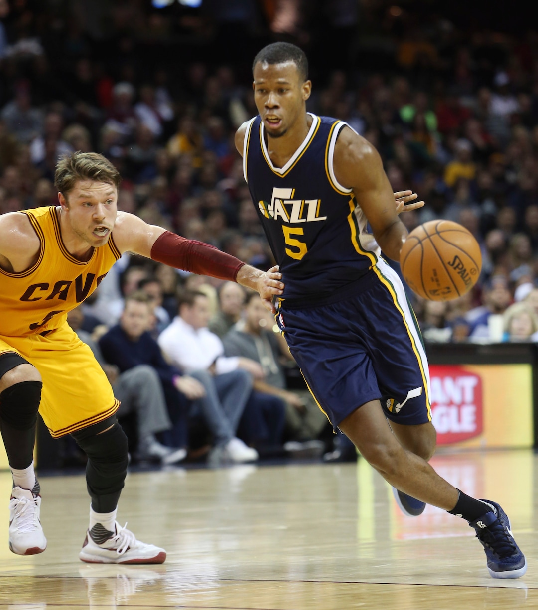 Utah Jazz guard Rodney Hood (5) drives around Cleveland Cavaliers guard Matthew Dellavedova (8) during the first half of an NBA basketball game Tuesday, Nov. 10, 2015, in Cleveland. (AP Photo/Ron Schwane)