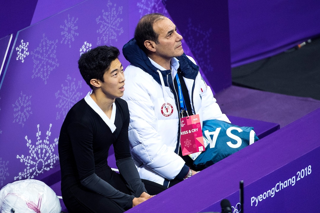 (Chris Detrick  |  The Salt Lake Tribune)  Salt Lake City's Nathan Chen and his coach Rafael Arutyunyan listen as Chen's score is announced in the Men Single Skating Free Skating at Gangneung Ice Arena during the Pyeongchang 2018 Winter Olympics Saturday, Feb. 17, 2018. Chen landed a record six quadruple jumps, scoring 215.08.