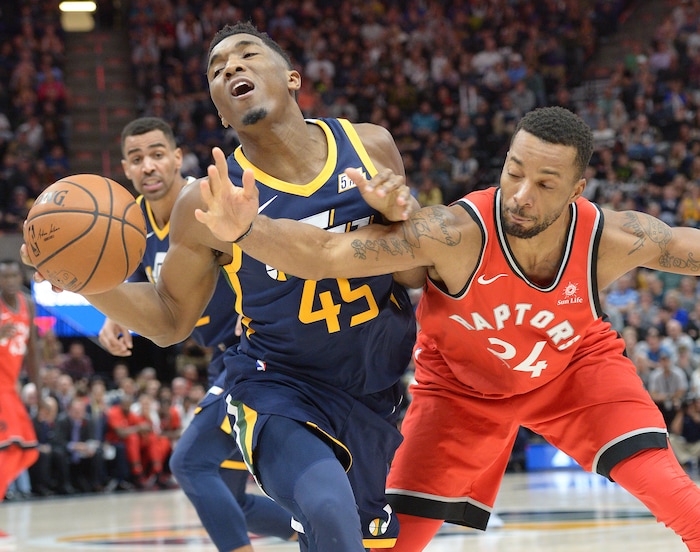 (Leah Hogsten  |  The Salt Lake Tribune) Utah Jazz guard Donovan Mitchell (45) is fouled by Toronto Raptors forward Norman Powell (24). The Utah Jazz were defeated by the Toronto Raptors 100-109 at Vivint Smart Home Arena, Friday, November 3, 2017