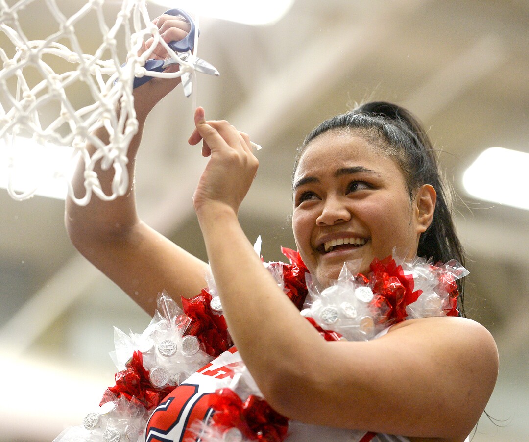 (Leah Hogsten  |  The Salt Lake Tribune)  East's Lynda Mahe (20) cuts down the net. East defeated Timpview 68-48 to win the the 5A High School Girls' Basketball Tournament title at SLCC in Taylorsville, Saturday, Feb. 24, 2018. 