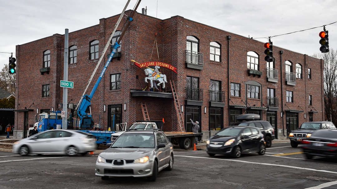 (Francisco Kjolseth  |  The Salt Lake Tribune)  The Salt Lake Costume Co. sign, originally designed by Lloyd S. Coley in the '50s while working for Rainbow Neon Sign Co., lives on once more as it is installed back home in its original location at 1700 S. 1100 East on Monday, Dec. 23, 2019, in what is now called the Salt Lake Costume Apartments.