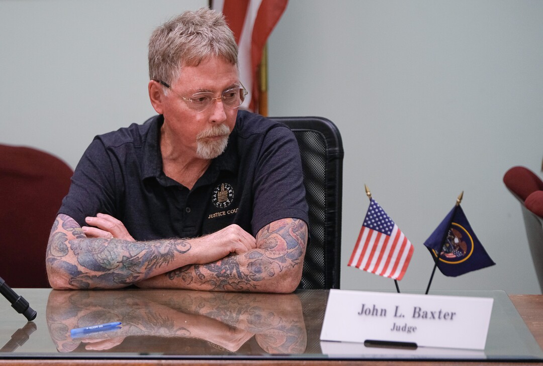 (Francisco Kjolseth  |  The Salt Lake Tribune)  Judge John L. Baxter patiently waits for another round of homeless court in the Weigand Center in Salt Lake City, June 28, 2019. Since May 2004, Salt Lake City has operated a homeless court, where transients can handle misdemeanor charges without showing up in regular court. This helps the homeless person by clearing outstanding warrants they have in a less intimidating environment and it also benefits the regular court by reducing its backlog of such cases. It's part of a larger effort on the part of the American Bar Association to decriminalize homelessness.