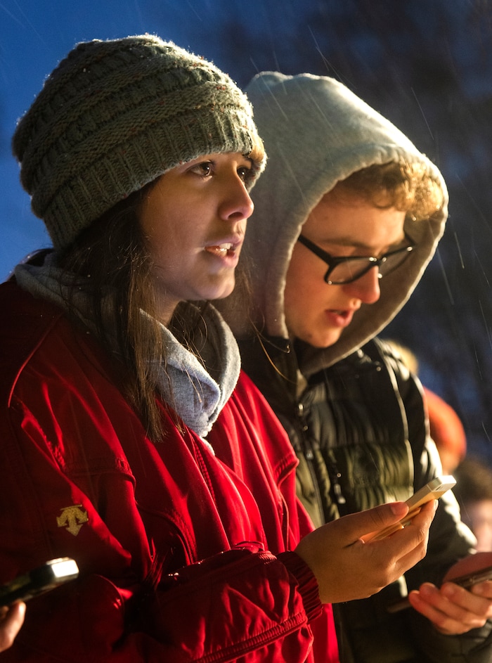 (Rick Egan  |  The Salt Lake Tribune)      Hailey Deeds and Matt Bailey sing a hymn with other BYU students, during a candlelight vigil on BYU campus, for the student who died by suicide this week, at the Tanner Building, Friday, Dec. 7, 2018.
  
