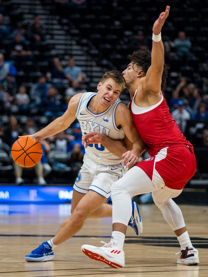 (Rick Egan | The Salt Lake Tribune)  Brigham Young Cougars guard Dallin Hall (30) tries to get past South Dakota Coyotes guard Damani Hayes (2), in basketball action between the Brigham Young Cougars and the South Dakota Coyotes, at Vivint Arena, in Salt Lake City, on Saturday, Dec. 3, 2022.
