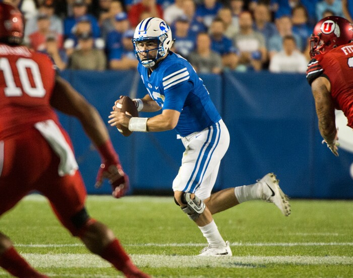 (Rick Egan  |  The Salt Lake Tribune)   Brigham Young Cougars quarterback Tanner Mangum (12) is chased by Utah Utes defensive end Kylie Fitts (11). in football action BYU vs Utah, at Lavell Edwards Stadium in Provo, Saturday, September 9, 2017.