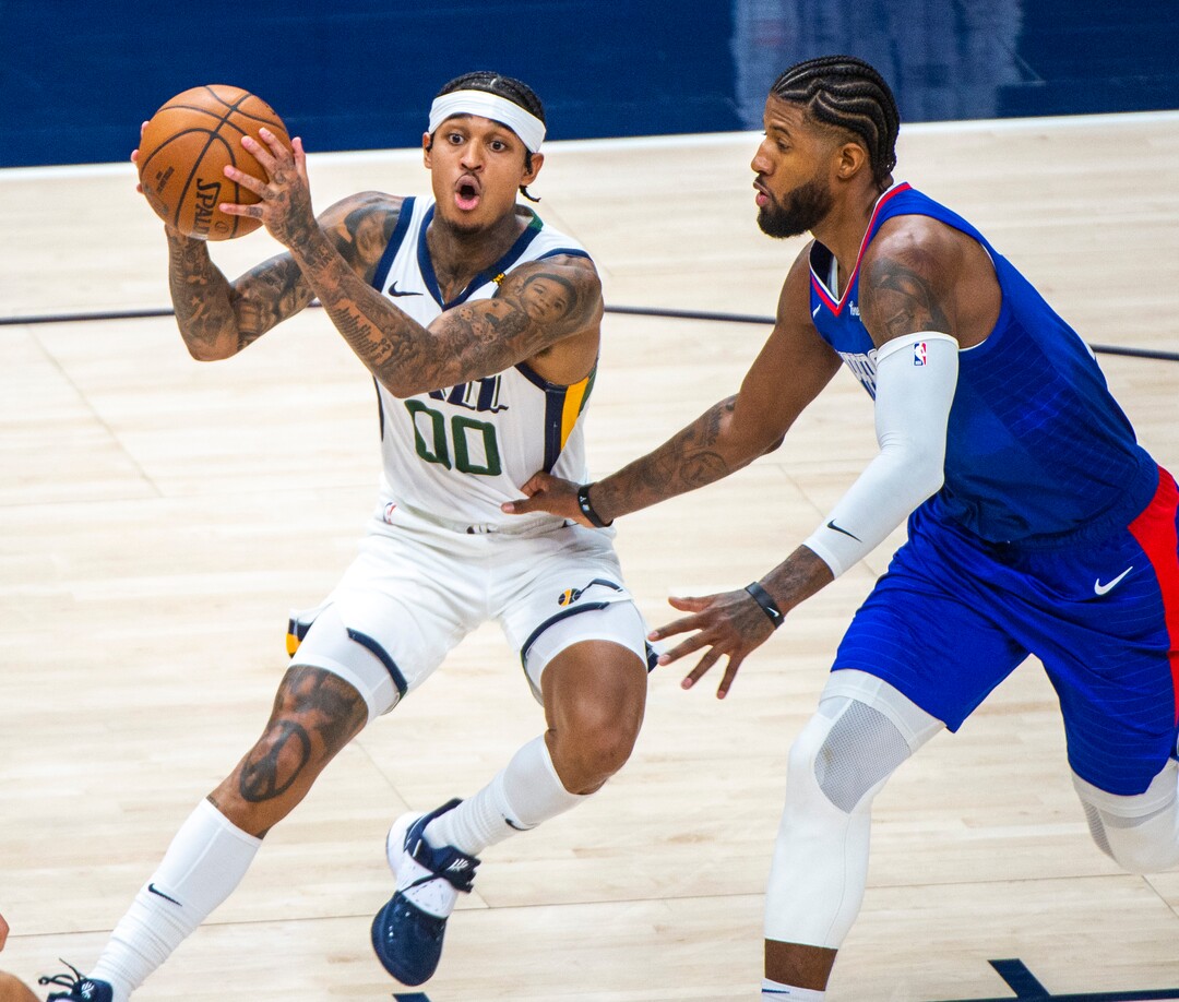 (Rick Egan | The Salt Lake Tribune) Utah Jazz guard Jordan Clarkson (00) makes a move, as LA Clippers guard Paul George (13) defends, in NBA action between the Utah Jazz and the LA Clippers at Vivint Arena, on Friday, Jan. 1, 2021.