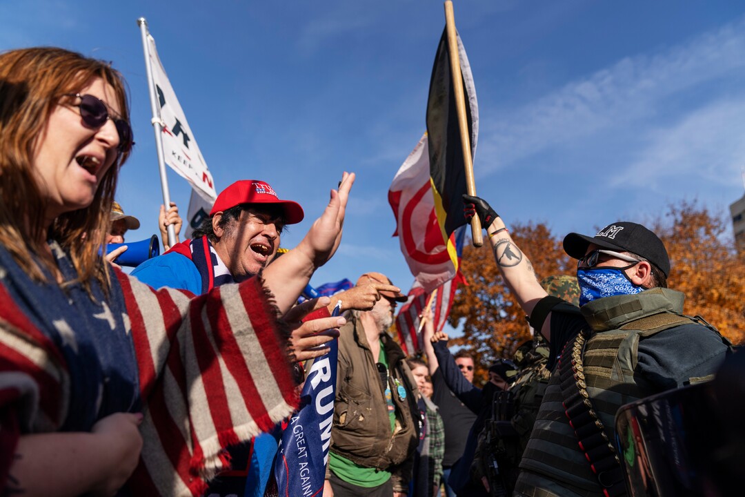 Trump supporters, at left, demonstrating the election results are confronted by counter protestors at the State Capitol in Lansing, Mich., Saturday, Nov. 7, 2020.  Democrat Joe Biden defeated President Donald Trump to become the 46th president of the United States on Saturday, positioning himself to lead a nation gripped by the historic pandemic and a confluence of economic and social turmoil.(AP Photo/David Goldman)