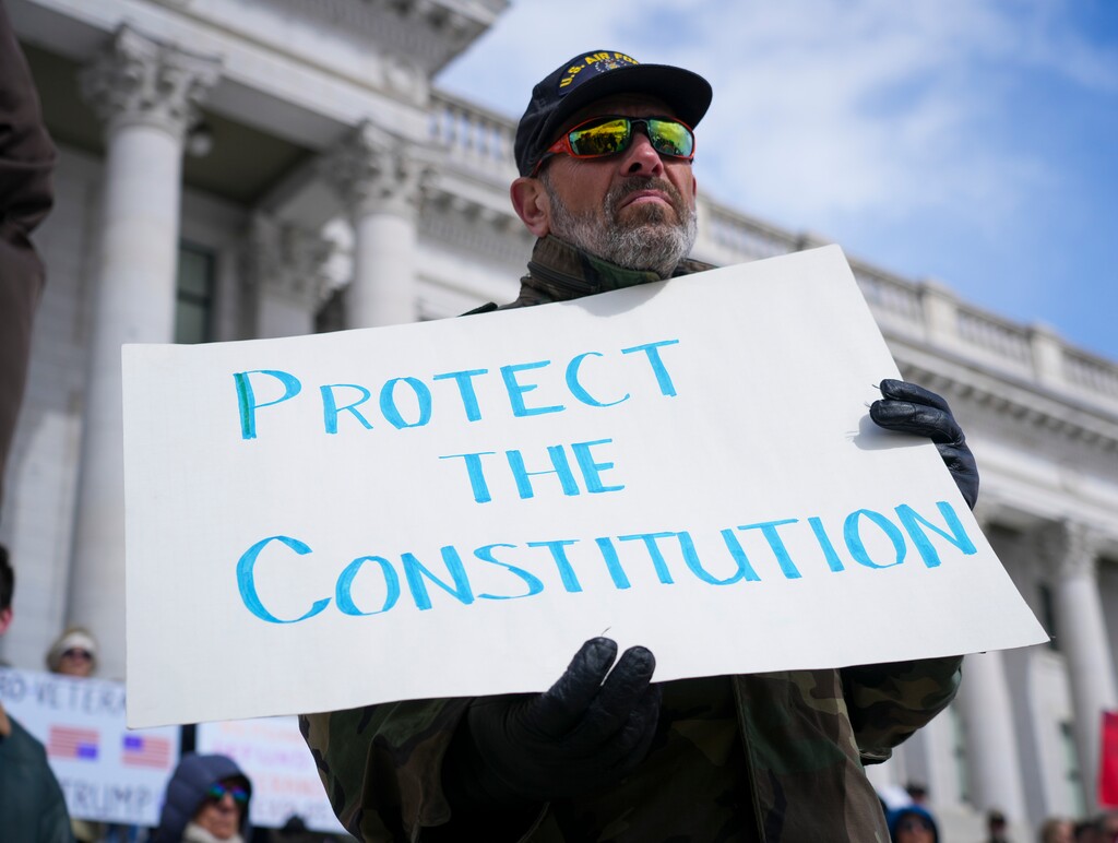(Bethany Baker  |  The Salt Lake Tribune) Veterans and supporters gather at the Utah Capitol in Salt Lake City for a protest in response to Trump administration policies on Friday, March 14, 2025.