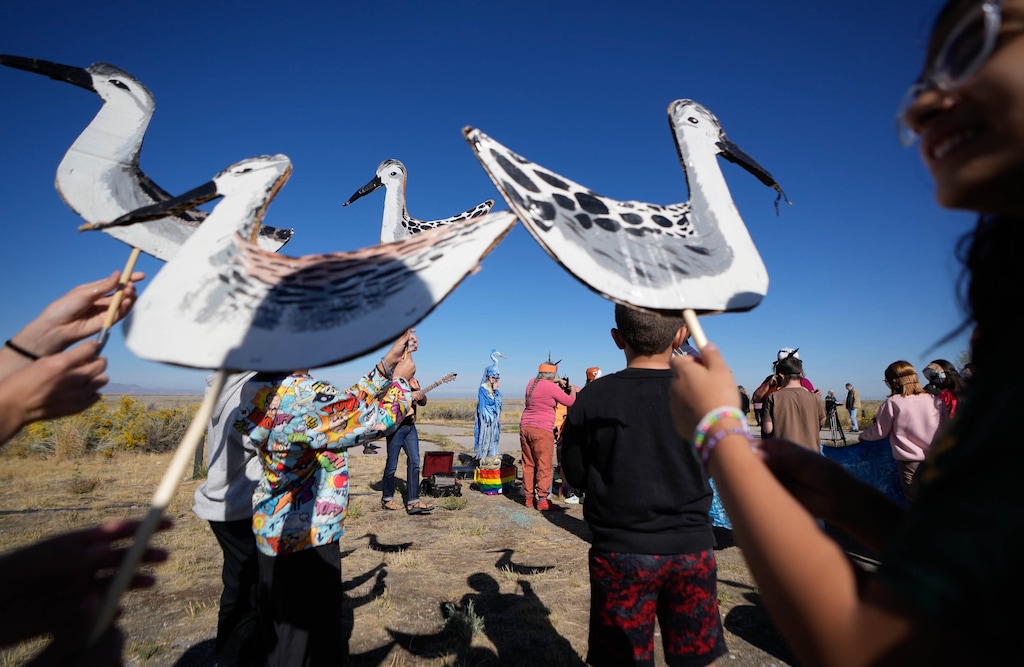 (Francisco Kjolseth | The Salt Lake Tribune) Bird costumes are distributed to 6th graders as they participate in a call to action to save the bird during a rally at the Great Salt Lake on Wednesday, Oct. 1, 2025. 