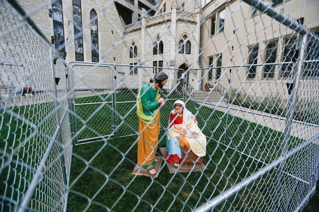 (Ebony Cox | The Indianapolis Star via AP)

This July 3, 2018, photo shows statues of Mary, Joseph and the baby Jesus in a cage of fencing topped with barbed wired on the lawn of Monument Circle's Christ Church Cathedral in Indianapolis. The statues were erected to protest the Trump administration's zero tolerance immigration policy.