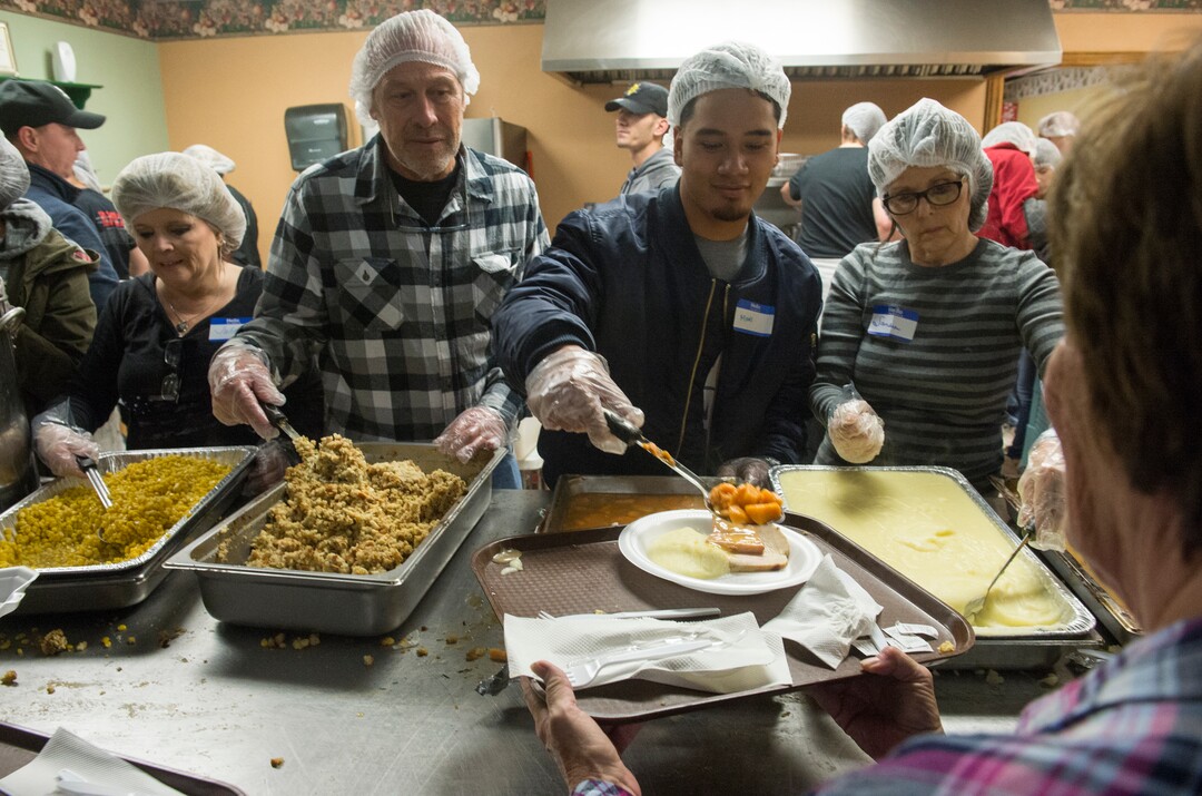 (Rick Egan  |  The Salt Lake Tribune)     Volunteers serve dinner at the 25th Annual Thanksgiving Dinner for the hungry and homeless at the Christian Life Center on Redwood Road in Salt Lake City, Wednesday, Nov. 21, 2018.