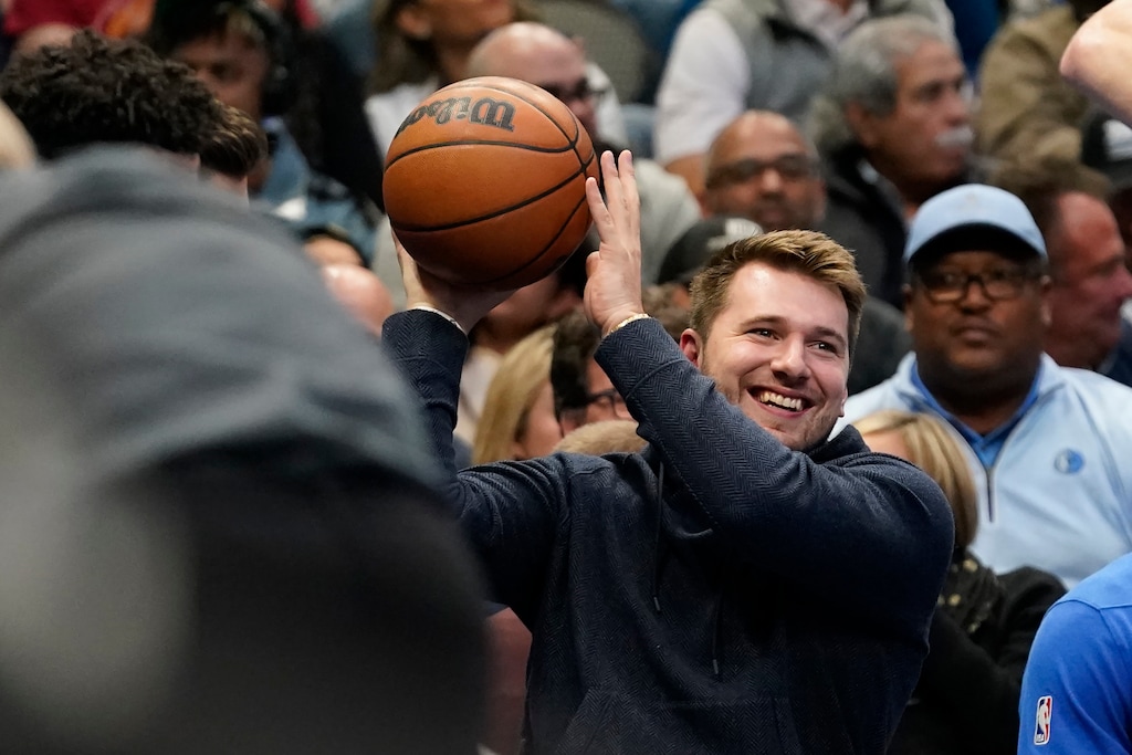(LM Otero | AP) Dallas Mavericks guard Luka Doncic, with the night off for rest, gets ready to toss the game ball from the bench during the first first half of the team's NBA basketball game against the Houston Rockets in Dallas, Wednesday, Nov. 16, 2022.
