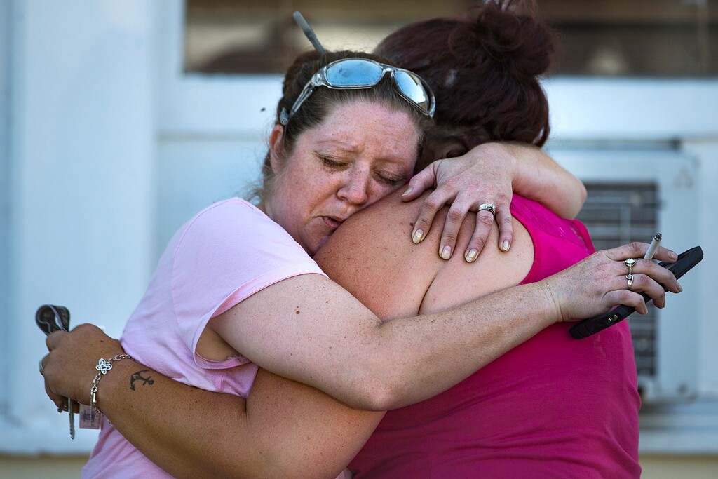 (Nick Wagner | Austin American-Statesman via AP) Carrie Matula embraces a woman after a fatal shooting at the First Baptist Church in Sutherland Springs, Texas, on Sunday, Nov. 5, 2017. Matula said she heard the shooting from the gas station where she works a block away.