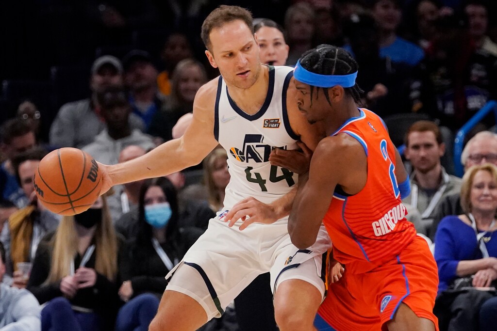 Utah Jazz forward Bojan Bogdanovic (44) drives against Oklahoma City Thunder guard Shai Gilgeous-Alexander (2) in the first half of an NBA basketball game Sunday, March 6, 2022, in Oklahoma City. (AP Photo/Sue Ogrocki)