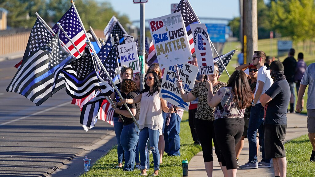 (Rick Bowmer | AP) Law enforcement supporters protest during a "Back the Blue" rally Thursday, Sept. 3, 2020, in West Valley City, Utah. A California woman charged with a hate crime in Utah after she trashed a "Back the Blue" sign in front of a deputy in Panguitch last year must pay a fine and write an apology letter to the officer, according to her plea agreement.