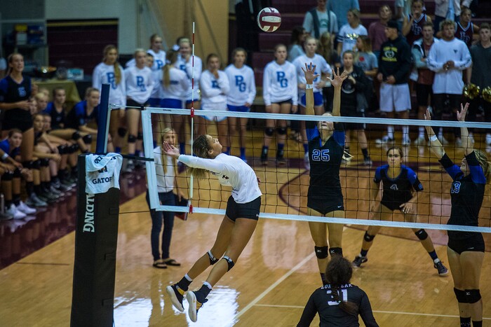 (Chris Detrick  |  The Salt Lake Tribune)    Lone Peak's Tasia Farmer (6) spikes the ball past Pleasant Grove's Ryley Daniel (25) and Pleasant Grove's Savannah Scott (13) during the volleyball match at Lone Peak High School Tuesday, September 5, 2017. 