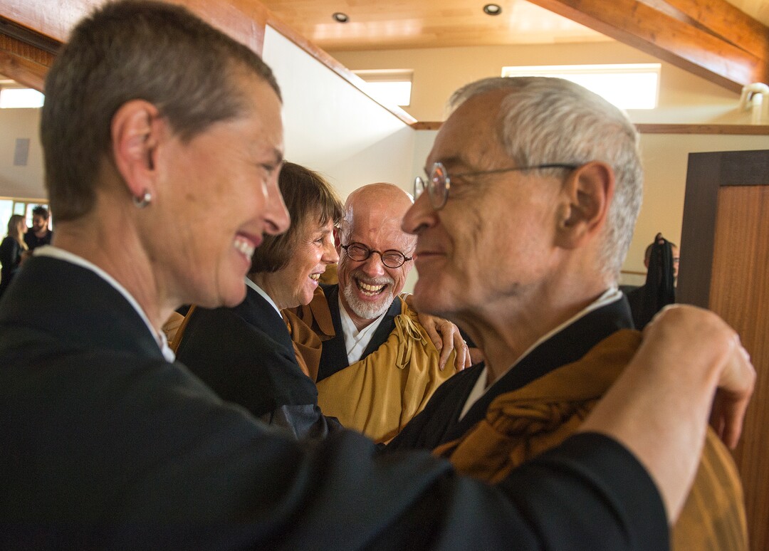 (Leah Hogsten  |  The Salt Lake Tribune) Catherine Genno Pages Roshi and Michael Mugaku Zimmerman Sensei (center) share a laugh as their respective spouses Michel Genko Dubois and Diane Musho Hamilton Sensei share a celebratory hug after the dedication and eye opening ceremony at Torrey Zendo Meditation Center, Sept. 13, 2017, in Torrey. The Torrey Zendo, founded by Diane Musho Hamilton Sensei and Michael Mugaku Zimmerman Sensei, located near Capitol Reef National Park, had been seasonal but is now a year-round facility for study, practice and retreats.