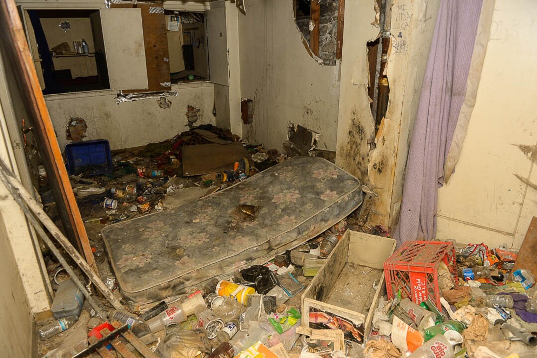(Trent Nelson | The Salt Lake Tribune)  Garbage from squatters fills the basement of a dilapidated, fire-damaged building near 100 South 700 East in Salt Lake City, Thursday Feb. 15, 2018. Other Side Academy has received approval to demolish it for their expansion.