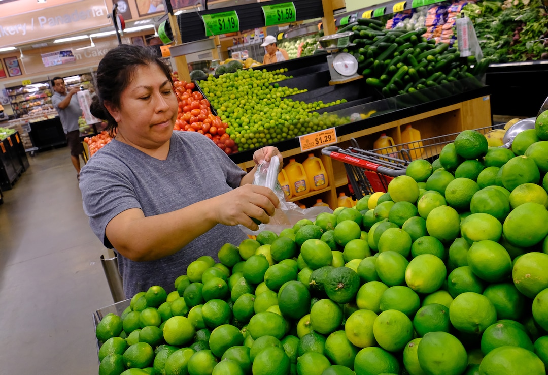 (Francisco Kjolseth  |  The Salt Lake Tribune)  Isela Martinez who likes shopping on days with store deals, pics out limes on Wed. June 20, 2018, at Rancho Market at North Temple and 900 West, a chain that started in 2006 and now has 10 stores. The owner says half of their shoppers are Latino, and it caters to other immigrant groups and long-time residents. New Census numbers show a continuing growth of minorities in Utah. Minorities have grown by 132k since the 2010 Census in Utah, and the Latino population has grown by 76k since then.