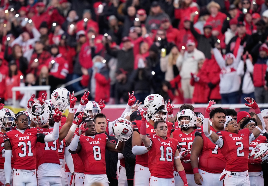 (Francisco Kjolseth | The Salt Lake Tribune) Players stand in honor of Ty Jordan and Aaron Lowe as a tribute is played on the screen at the end of the third quarter during their game against Colorado on Friday, Nov. 26, 2021.