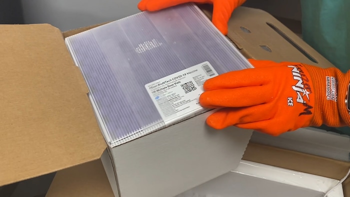 (Photos courtesy Intermountain Healthcare) An employee at Utah Valley Hospital in Provo unboxes the state of Utah's first batch of COVID-19 vaccine, on Monday, Dec. 14, 2020. The vaccine, developed by Pfizer Inc. and BioNTech, must be stored at around 95 degrees below zero Fahrenheit, so it is shipped surrounded by dry ice and stored in a supercold freezer.