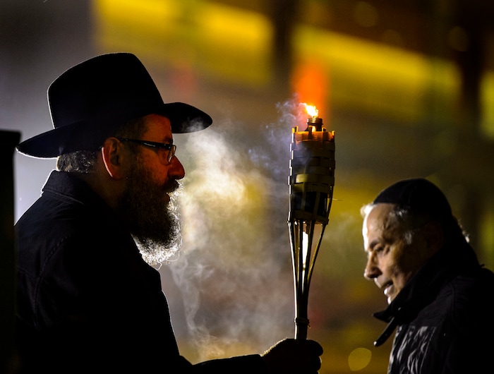 (Steve Griffin  |  The Salt Lake Tribune)   Rabbi Benny Zippel of Chabad Lubavitch is joined by John Price as they prepare to light a giant menorah for the first night of Hanukkah, the Jewish eight day festival of lights outside, Abravanel Hall in Salt Lake City Tuesday December 12, 2017.
