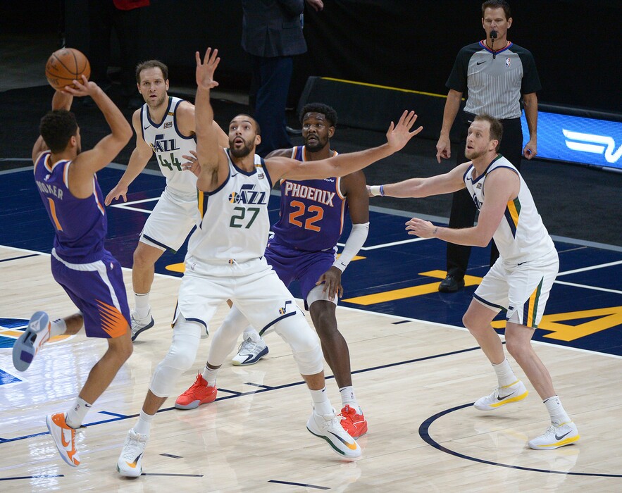 (Leah Hogsten  |  The Salt Lake Tribune) Phoenix Suns guard Devin Booker (1) drives to the net to Utah Jazz center Rudy Gobert (27) as the Jazz crack open their 2020-21 preseason with their second game against the Phoenix Suns, Dec. 14, 2020. 