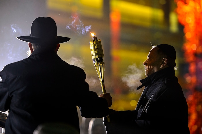 (Steve Griffin  |  The Salt Lake Tribune)   Rabbi Benny Zippel of Chabad Lubavitch is joined by John Price as they prepare to light a giant menorah for the first night of Hanukkah, the Jewish eight day festival of lights outside, Abravanel Hall in Salt Lake City Tuesday December 12, 2017.
