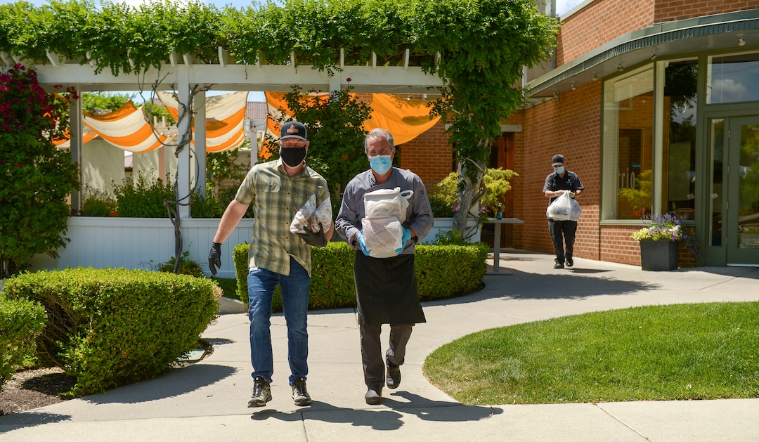 (Leah Hogsten  |  The Salt Lake Tribune) l-r Nicholas & Co. sales vice-president Scott Albert and Trio restaurant owner Mikel Trapp load 27 boxes of food for transport to feed frontline workers June 3, 2020. Since March, the Helping Heroes program, launched by Utah restaurant food supplier, Nicholas & Co., has been taking food originally planned for restaurants and using it to feed frontline COVID-19 workers across the Wasatch Front.